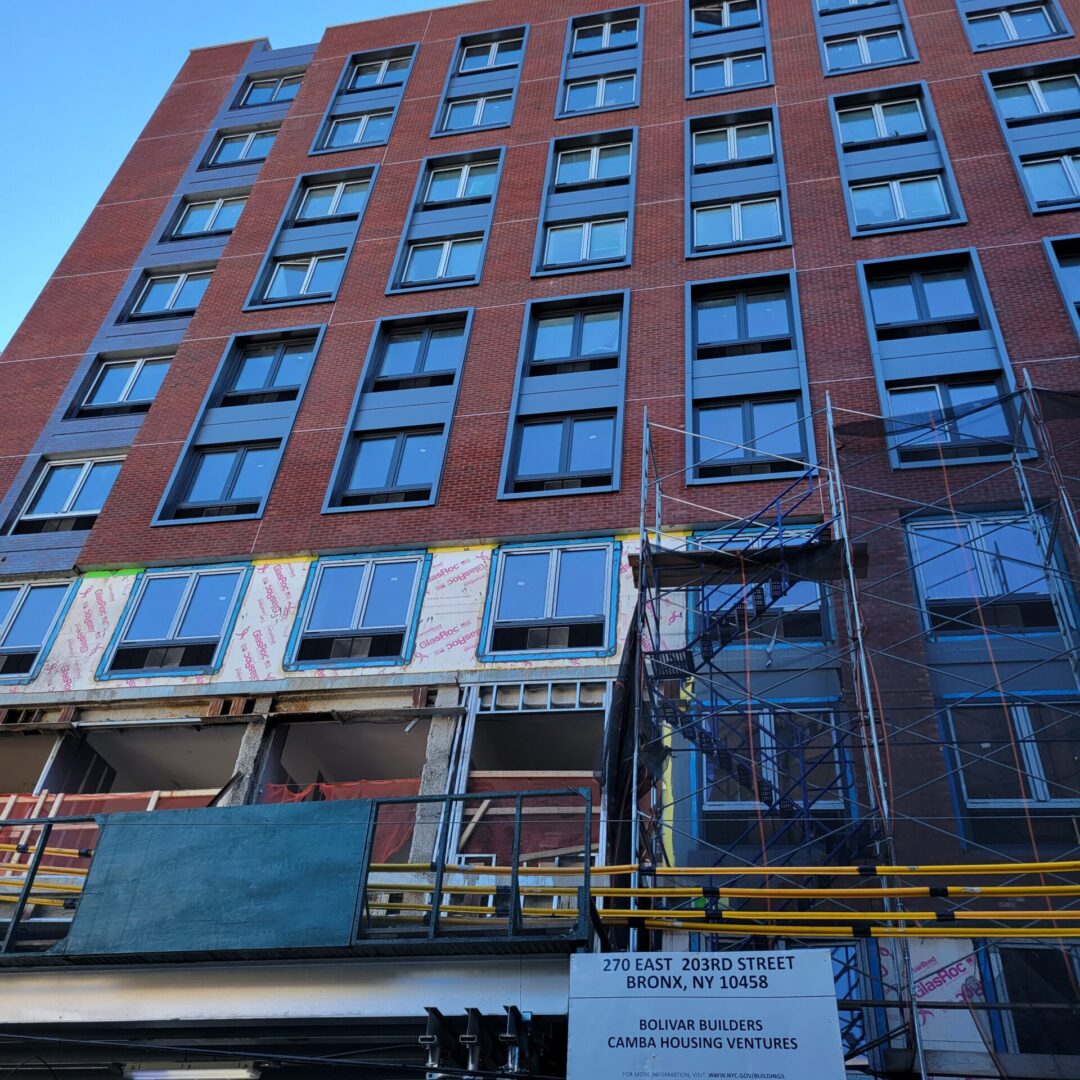 A building that has been painted red and is under construction.