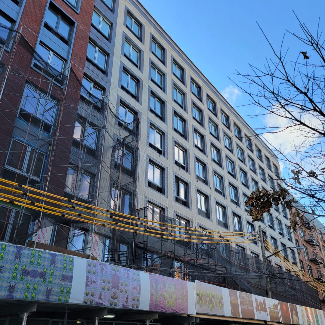 A building with many windows and trees in the background