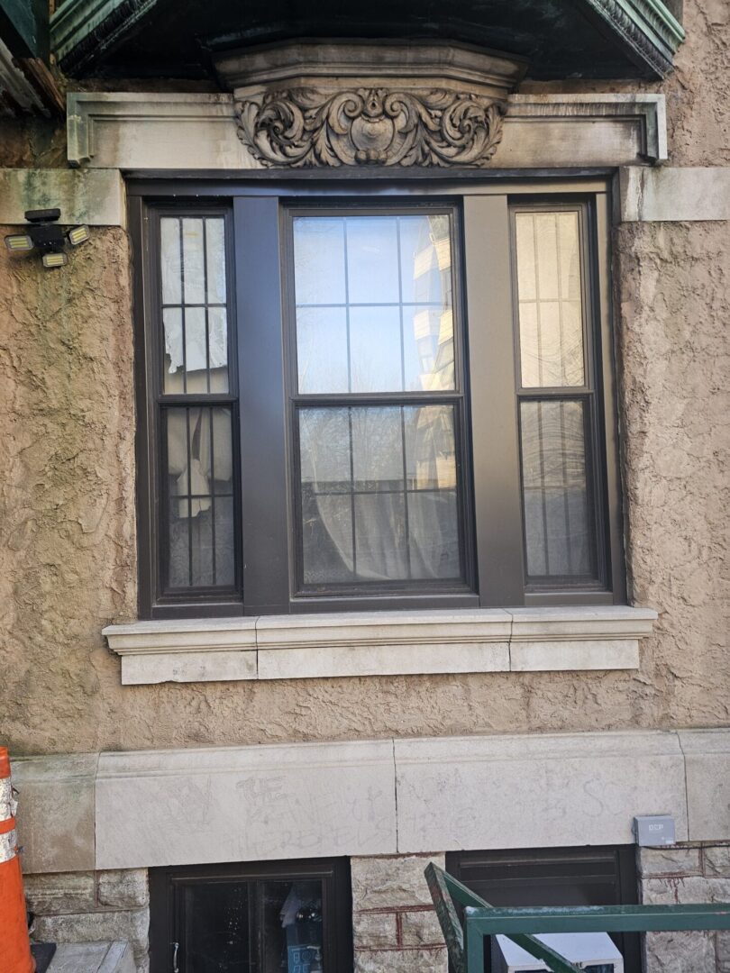 A window with a wrought iron design on it.